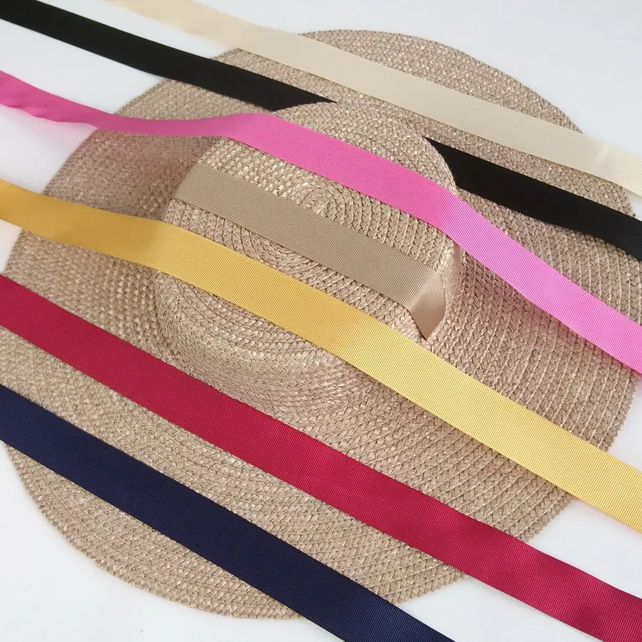 Oyster Straw Hat with ribbons overlayed in navy, red, yellow, gold, pink, black and ivory