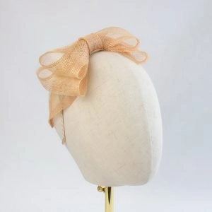 Apricot Large Sinamay Bow Fascinator - side, angled view of fascinator