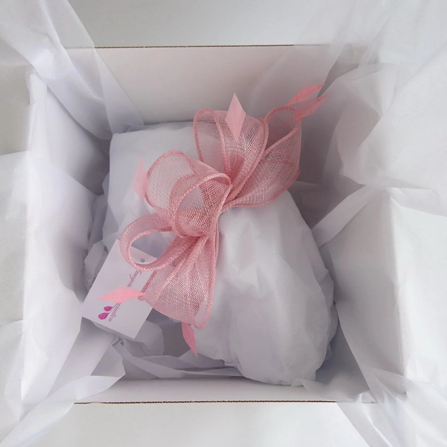 Imogen's Imagination fascinator packed in a hat box with white tissue paper