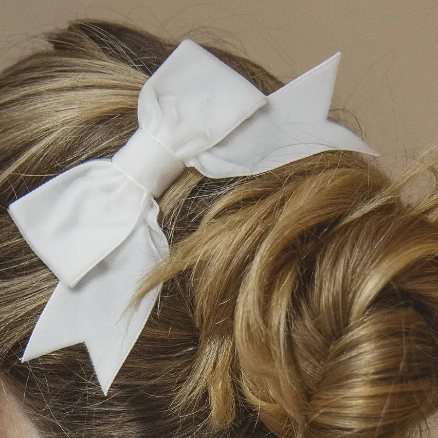 Off White Velvet Hair Bow worn to the side of a messy bun