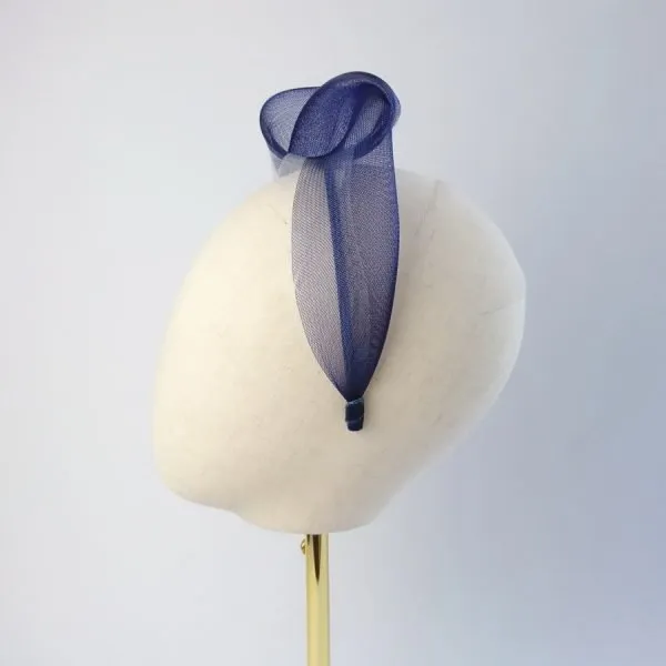 Navy White vegan friendly knotted headband worn to the right of the head