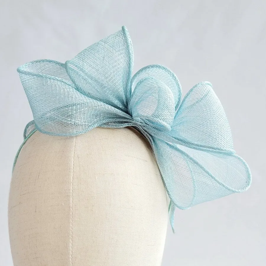 Aqua Blue Looped Fascinator Headband worn to the left of the head