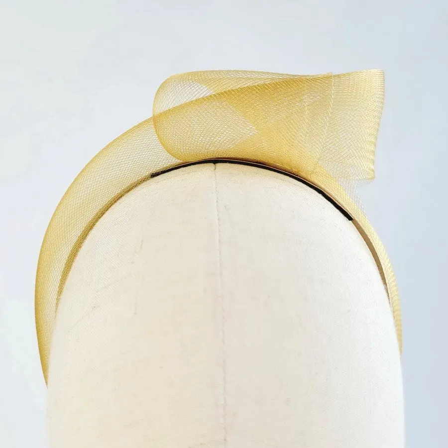 Mustard statement knot headband worn to the left of the head