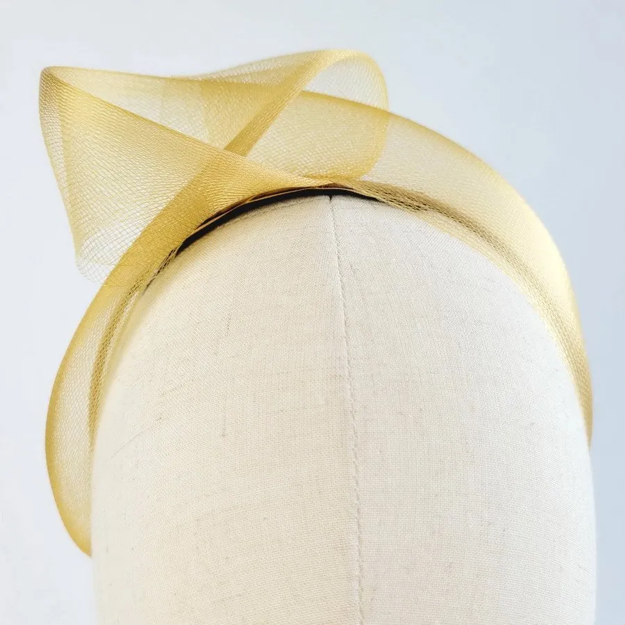 Detail of Mustard Crinoline Knot Headband worn to the right of the head