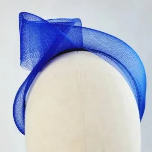 Royal blue vegan friendly knotted headband worn to the right of the head