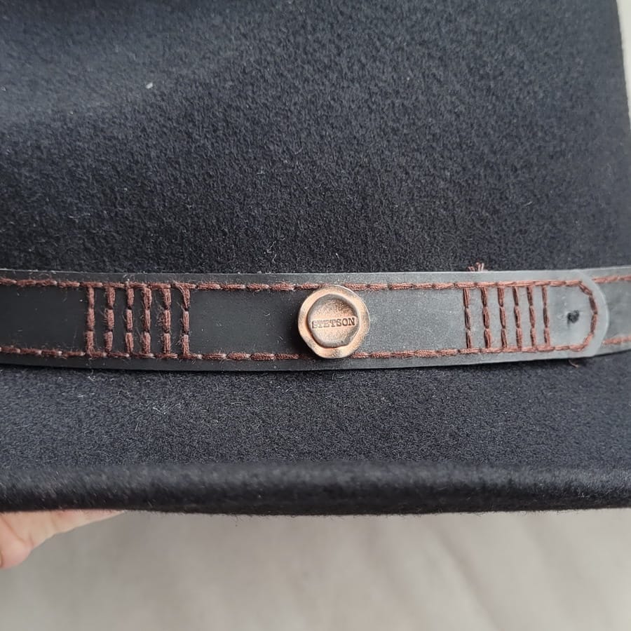 Before and after cleaning - fully cleaned hat band to the left of the Stetson Stud