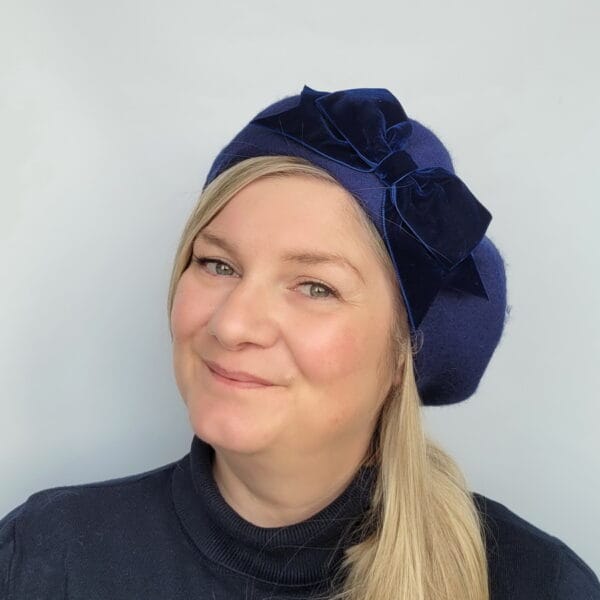 Navy Blue Beret with Navy Velvet Ribbon Bow worn by a white woman in her 40s with long blonde hair