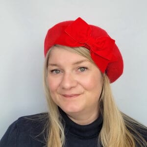 Red Beret with Red Velvet Ribbon Bow worn by a white woman in her 40s with long blonde hair
